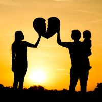 Silhouettes of a couple holding a broken heart symbol against a sunset, representing child custody issues and family law themes relevant to The Law Office of Fedor Kozlov, P.C.
