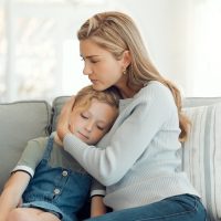 divorce Mother comforting child during difficult conversation about divorce, emphasizing emotional support and connection.