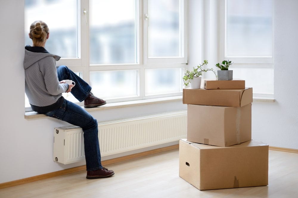 WomanMoverWithCardboardBoxesMovingInOutCityApartment WomanMoverWithCardboardBoxesMovingInOutCityApartment