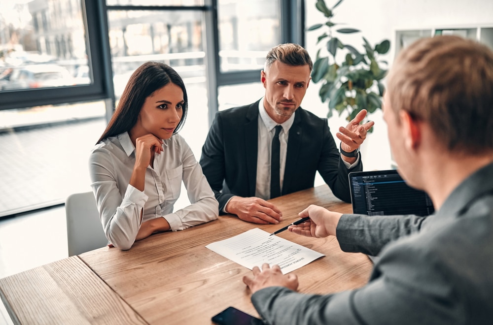 CoupleSigningDivorceAgreementMaleLawyerGivingDocumentsToHusband CoupleSigningDivorceAgreementMaleLawyerGivingDocumentsToHusband