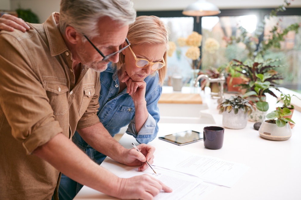 MatureCoupleReviewingAndSigningDomesticFinancesAndInvestmentPaperwork MatureCoupleReviewingAndSigningDomesticFinancesAndInvestmentPaperwork