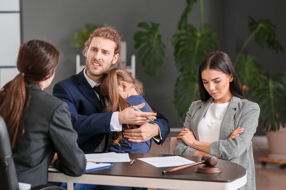 YoungCoupleAndTheirDaughterVisitingDivorceLawyerInOffice YoungCoupleAndTheirDaughterVisitingDivorceLawyerInOffice