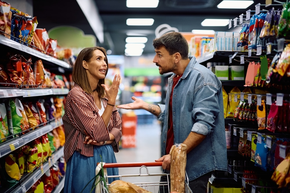 MidAdultCoupleArguingWhileShoppingInSupermarket MidAdultCoupleArguingWhileShoppingInSupermarket