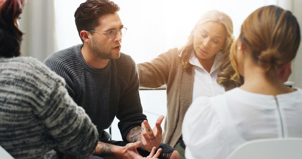 SupportGroupCounselingAndSadManInCircleForAddiction SupportGroupCounselingAndSadManInCircleForAddiction
