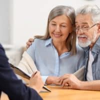 NotaryConsultingSeniorCoupleAboutLastWillAndTestamentIn