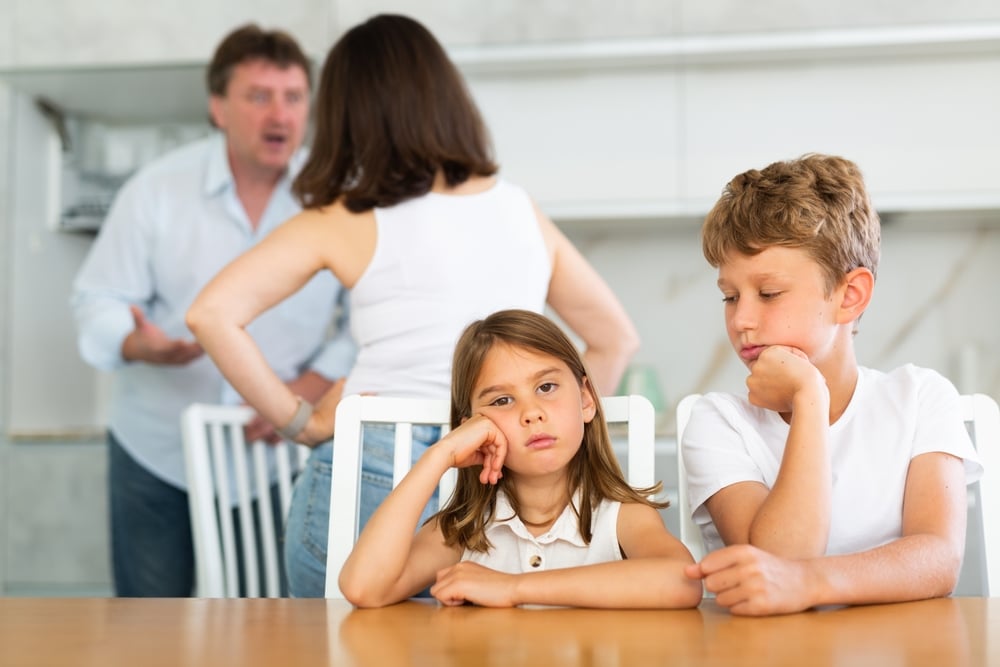 ChildrenAreSittingAtKitchenTableAndHearTheirParents