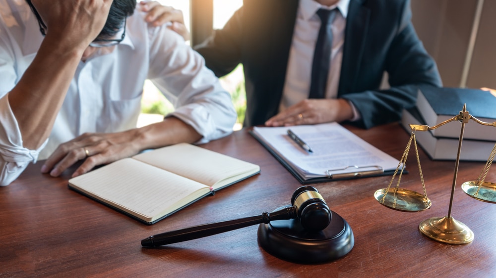 MaleNotaryLawyerOrJudgeConsultOrDiscussingContractPapers