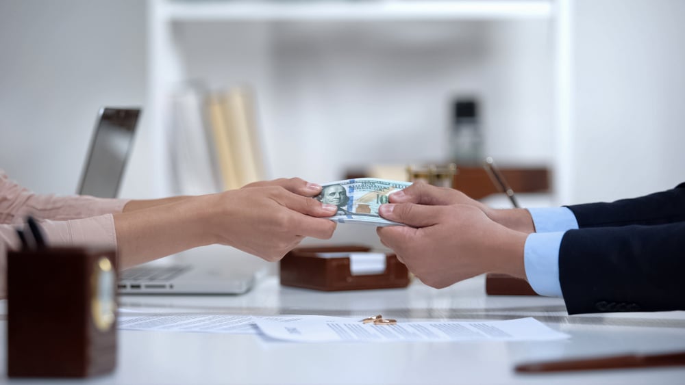 MaleAndFemaleHandsPullingMoneyDividingMaritalPropertyDuring MaleAndFemaleHandsPullingMoneyDividingMaritalPropertyDuring