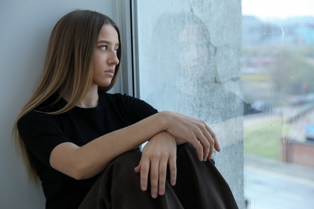 DepressedTeenageGirlNearWindowAtHome DepressedTeenageGirlNearWindowAtHome
